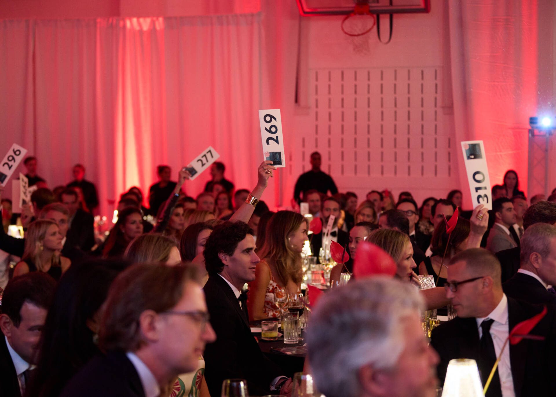 Guests holding up auction paddles during the live auction