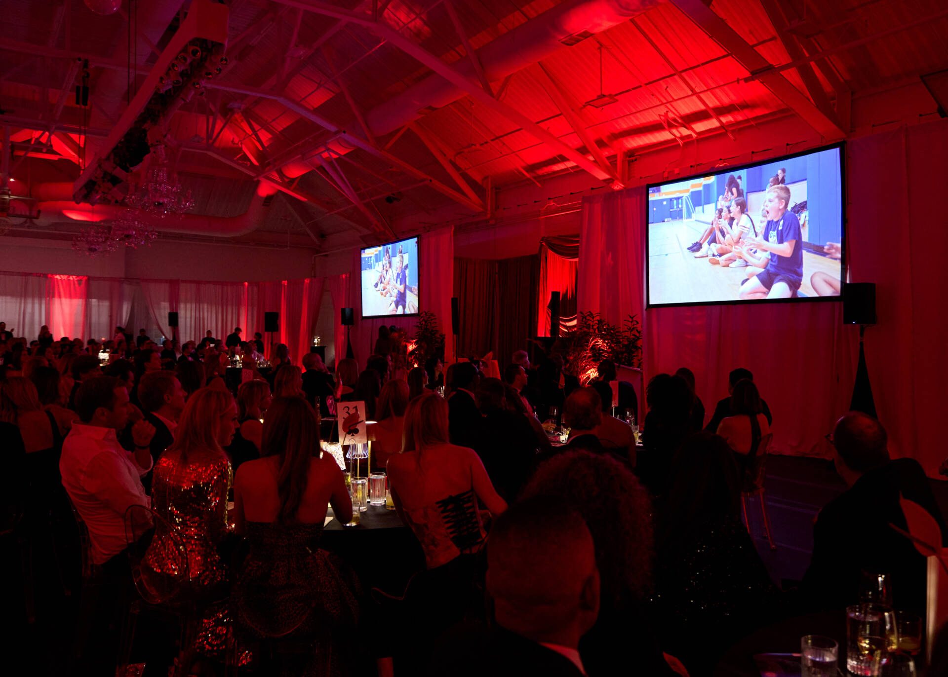 Red lit gala room at the Boys & Girls Club of Greenwich annual benefit