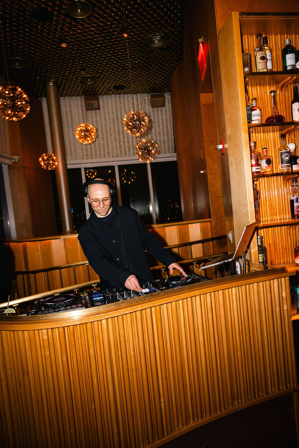 B.MILLS performing at a luxury corporate benefit event inside the premium booth setup