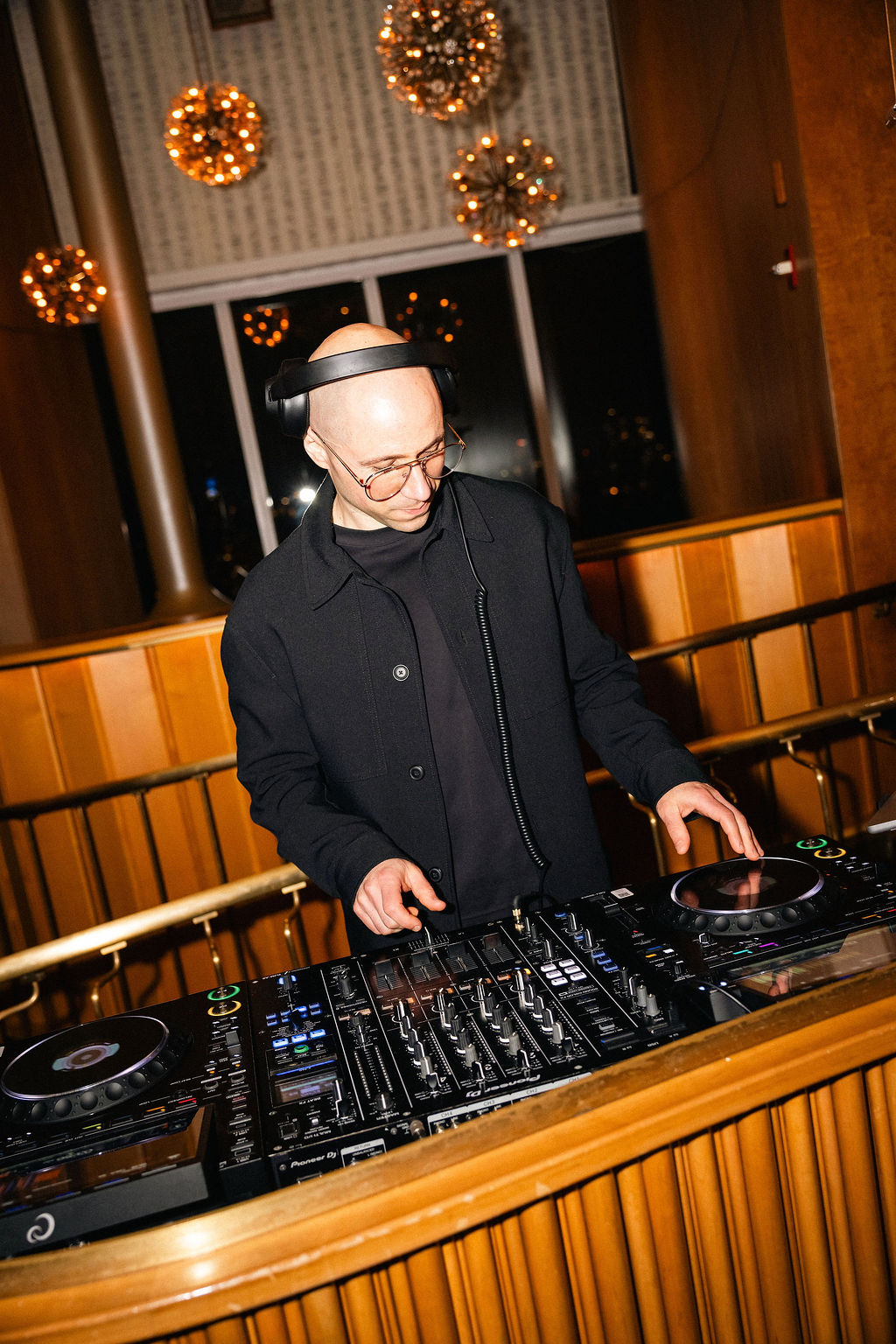 B.MILLS mixing live audio on professional sound controller deck at corporate function